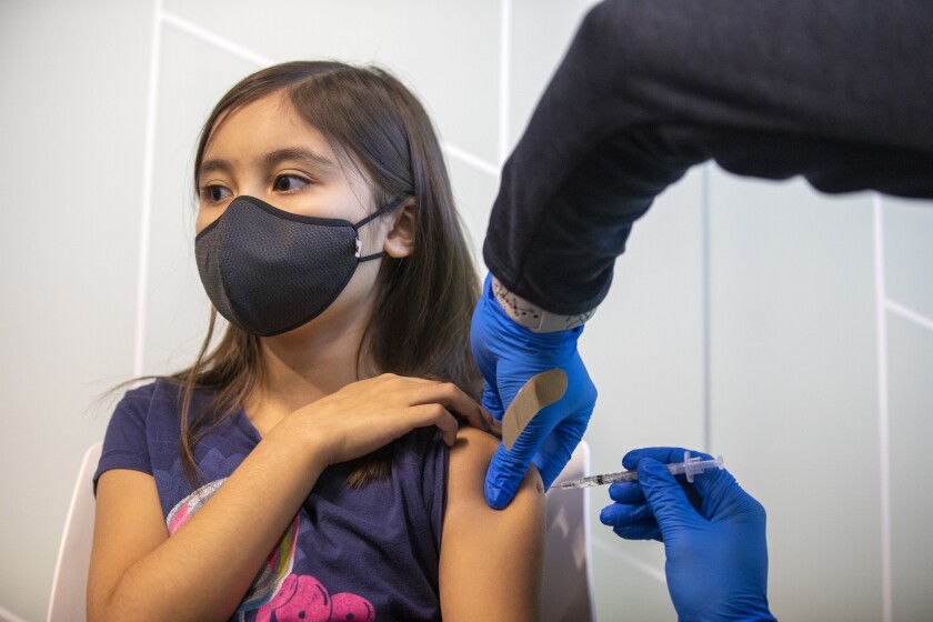 A child receives a dose of COVID-19 vaccine.