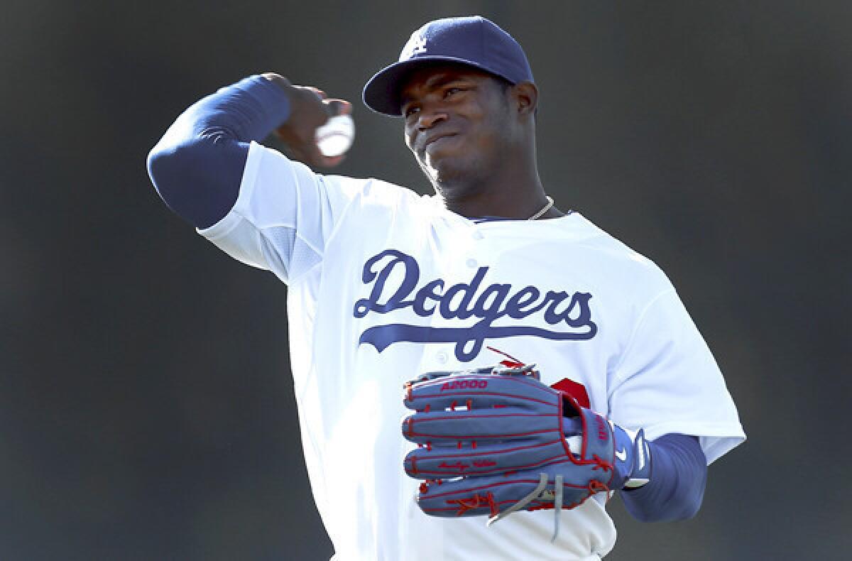 Dodgers outfielder Yasiel Puig, who has an injured thigh, has been on a limited throwing schedule during spring workouts because of a sore shoulder.