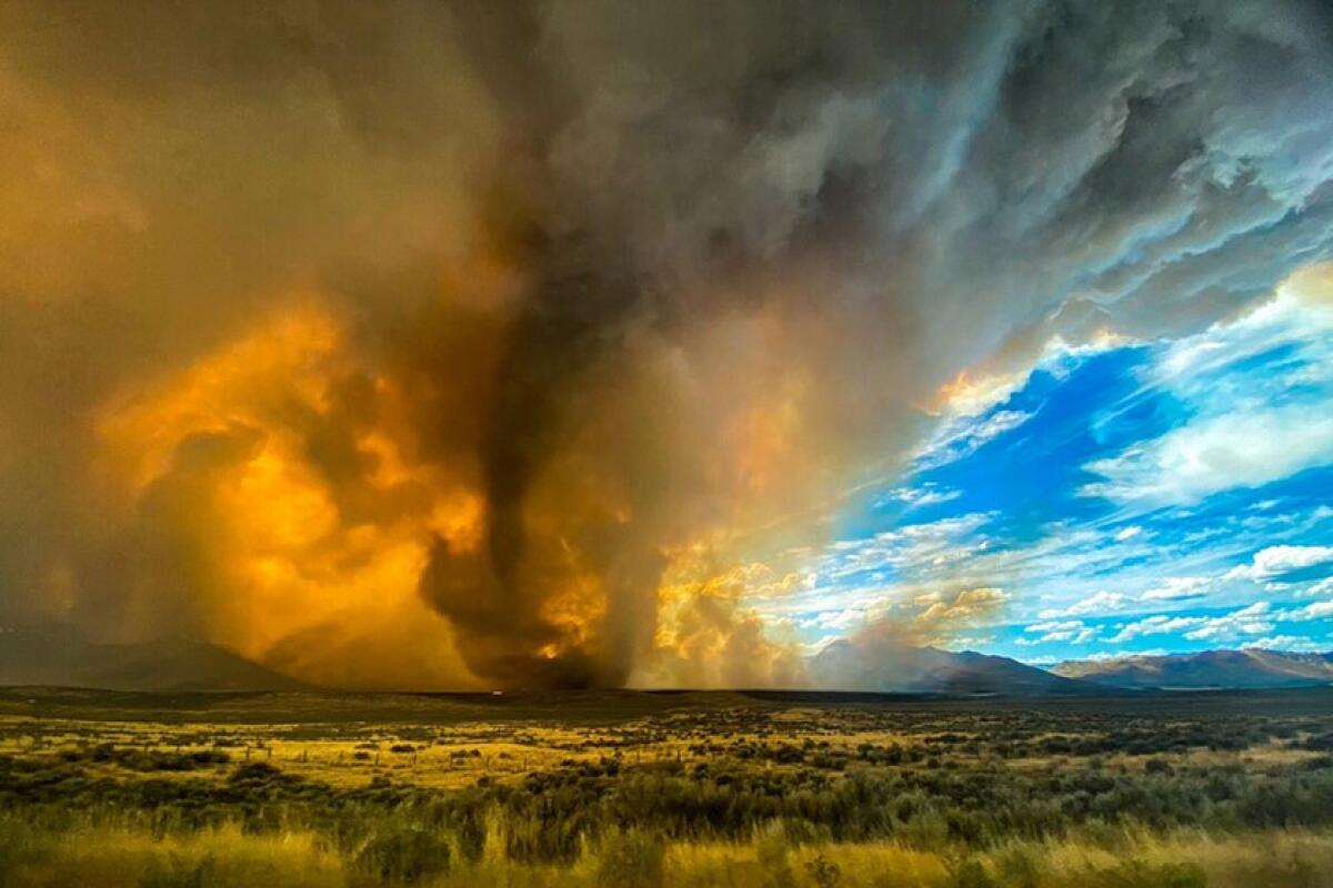 A funnel appears in a thick plume of smoke from the Loyalton Fire in Lassen County, Calif., on Saturday.