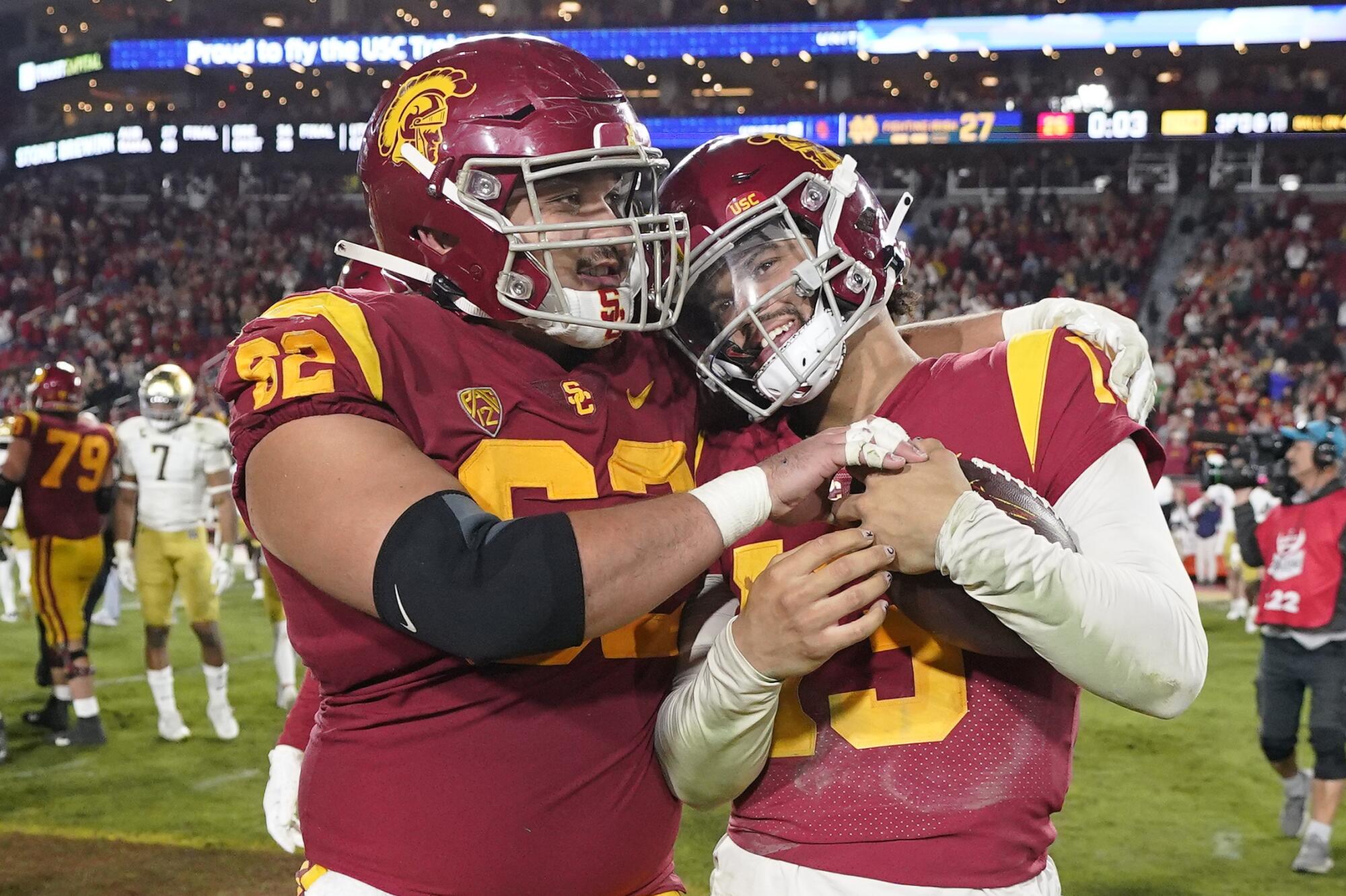 USC quarterback Caleb Williams gets a hug from offensive lineman Brett Neilon after the Trojans defeated Notre Dame 