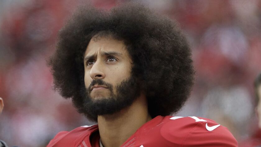 Colin Kaepernick stands in the bench area during a game between the San Francisco 49ers and New York Jets.