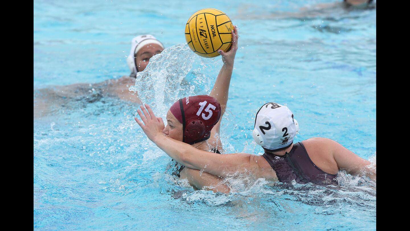 Laguna's Claire Kelly shoots and scores despite a hand in the face by Point Loma's Kristin Smith during first round of the CIF Southern California Regional Division II playoffs at Corona Del Mar high on Friday.