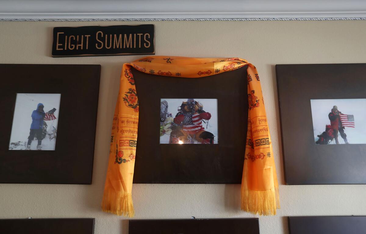 A scarf hangs around a picture of one of Bill Burke's climbing adventures.
