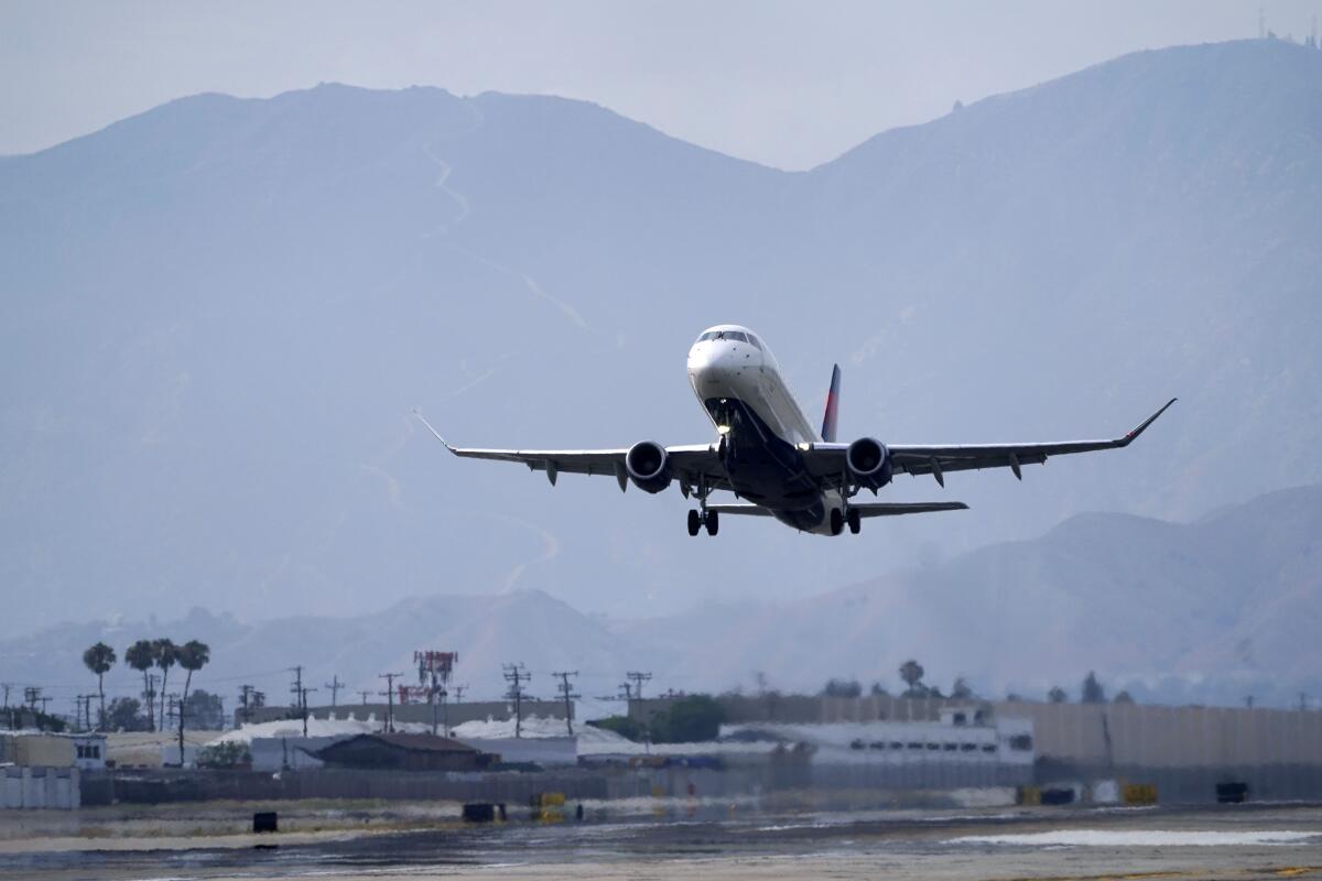 A passenger jet takes off from an airport runway