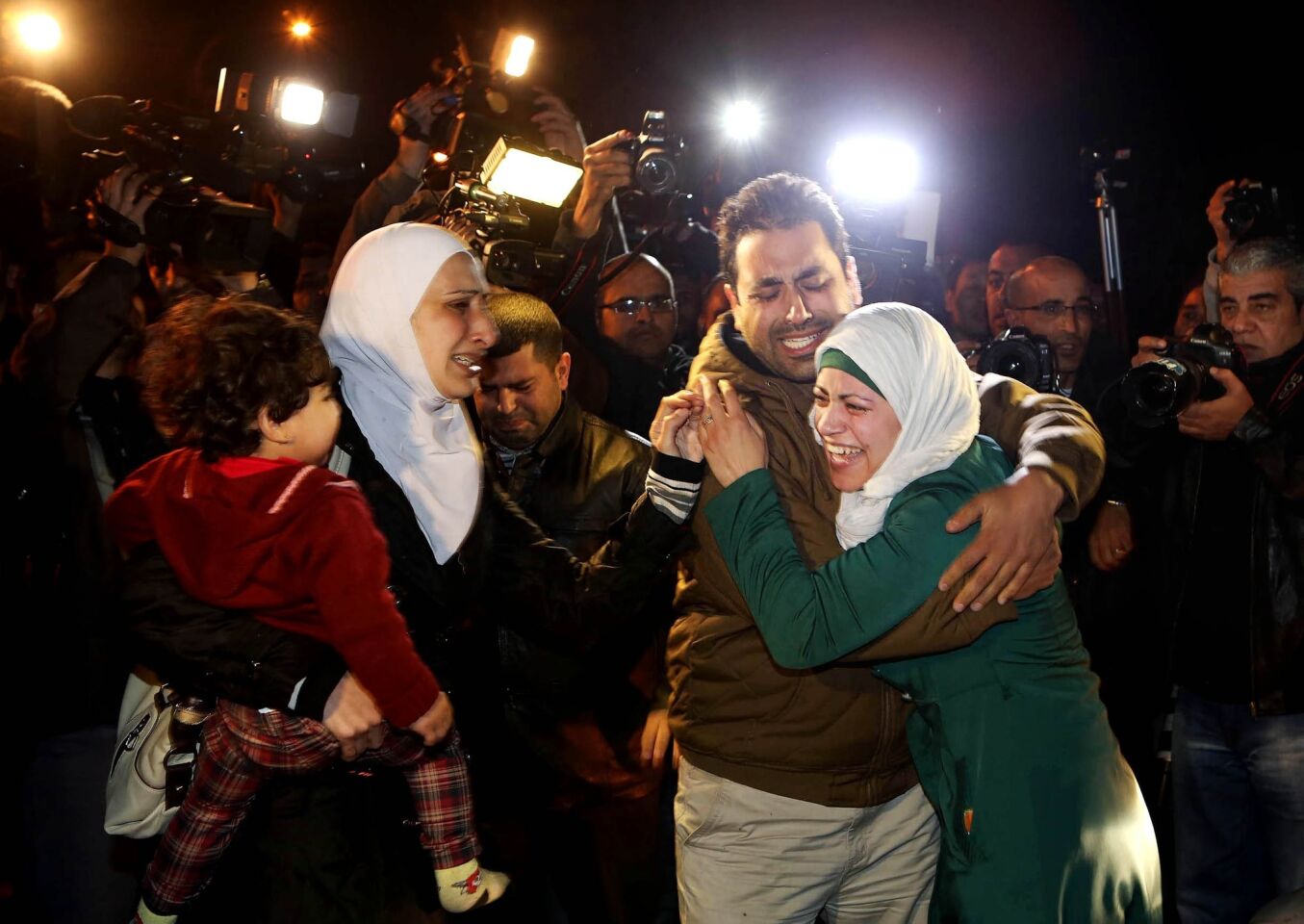 A man comforts the wife of captive Jordanian pilot Lt. Moaz Kasasbeh during a protest in Amman, Jordan, on Wednesday.
