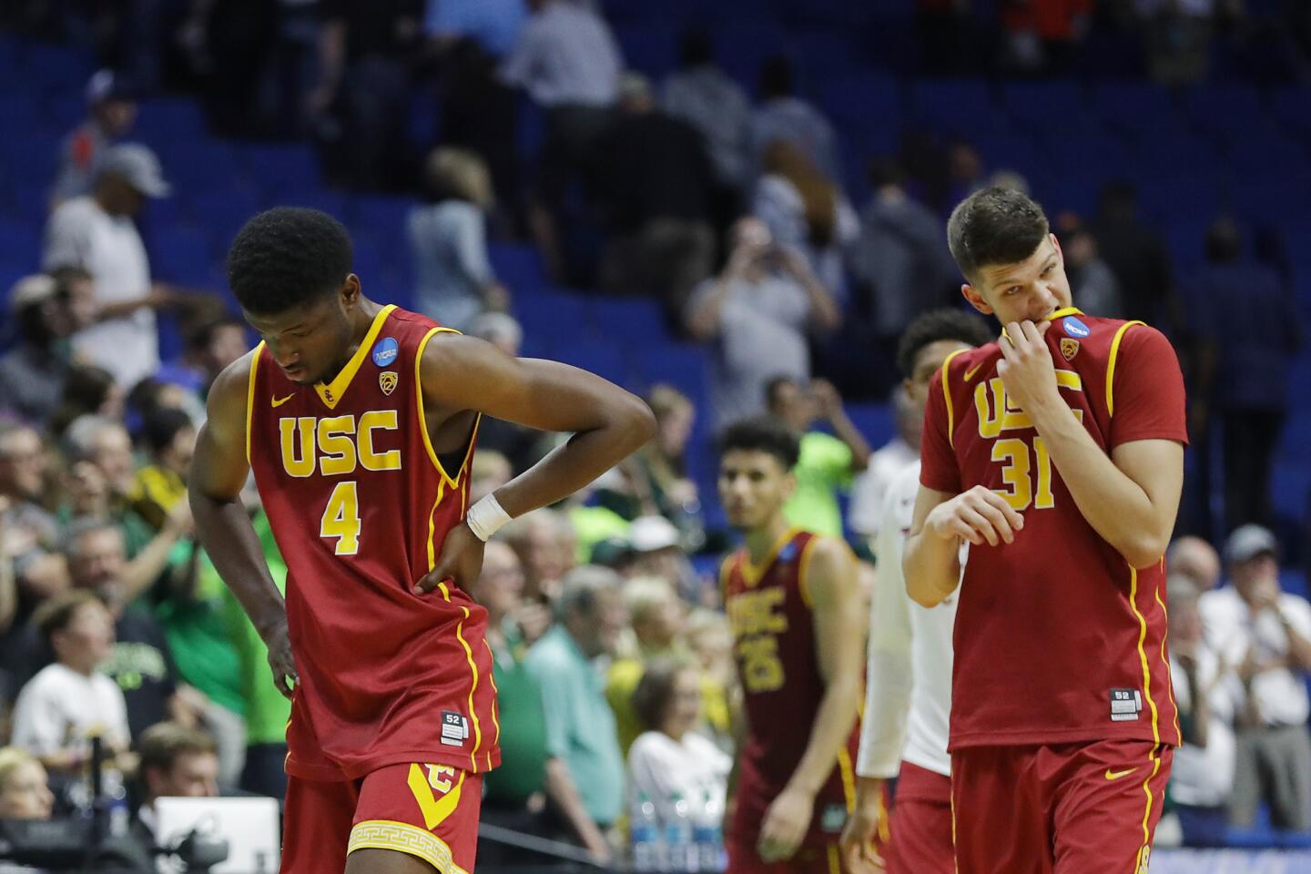 USC big men Chimezie Metu (4) and Nick Rakocevic (31) leave the court after their 82-78 loss to Baylor in an NCAA tournament second-round game Sunday.