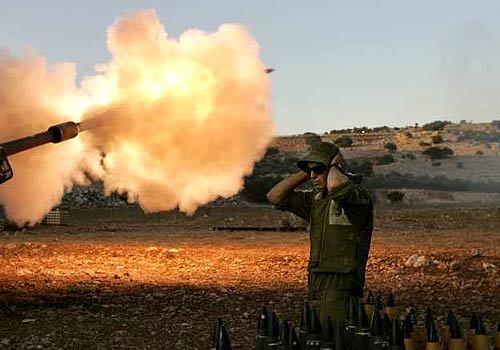 Israeli soldiers fire artillery from their position near the Lebanese border in northern Israel Tuesday.