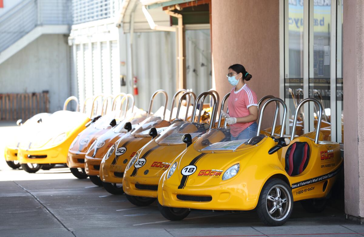 A worker waits for customers at GoCar Tours in San Francisco.