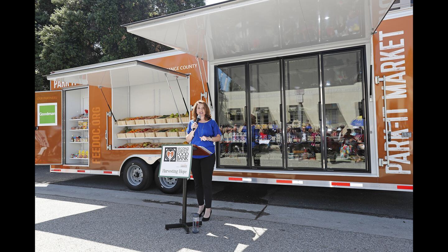 Nicole Suydam, CEO of Second Harvest Food Bank of Orange County, speaks during the Park-It Market launch at Village Center Apartments in Anaheim on May 9. Park-It Market is the nation’s first free, walk-up mobile market designed to provide fresh, nutritious food to seniors as it travels throughout Orange County on scheduled visits.