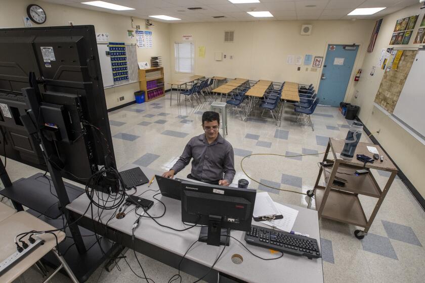 WOODLAND HILLS, CA - AUGUST 11: Student desks are pushed off to the side in a classroom at El Camino Real Charter High School as teacher Manuel Velarde instructs his Spanish 2 class online Tuesday, Aug. 11, 2020 in Woodland Hills, CA. (Brian van der Brug / Los Angeles Times)