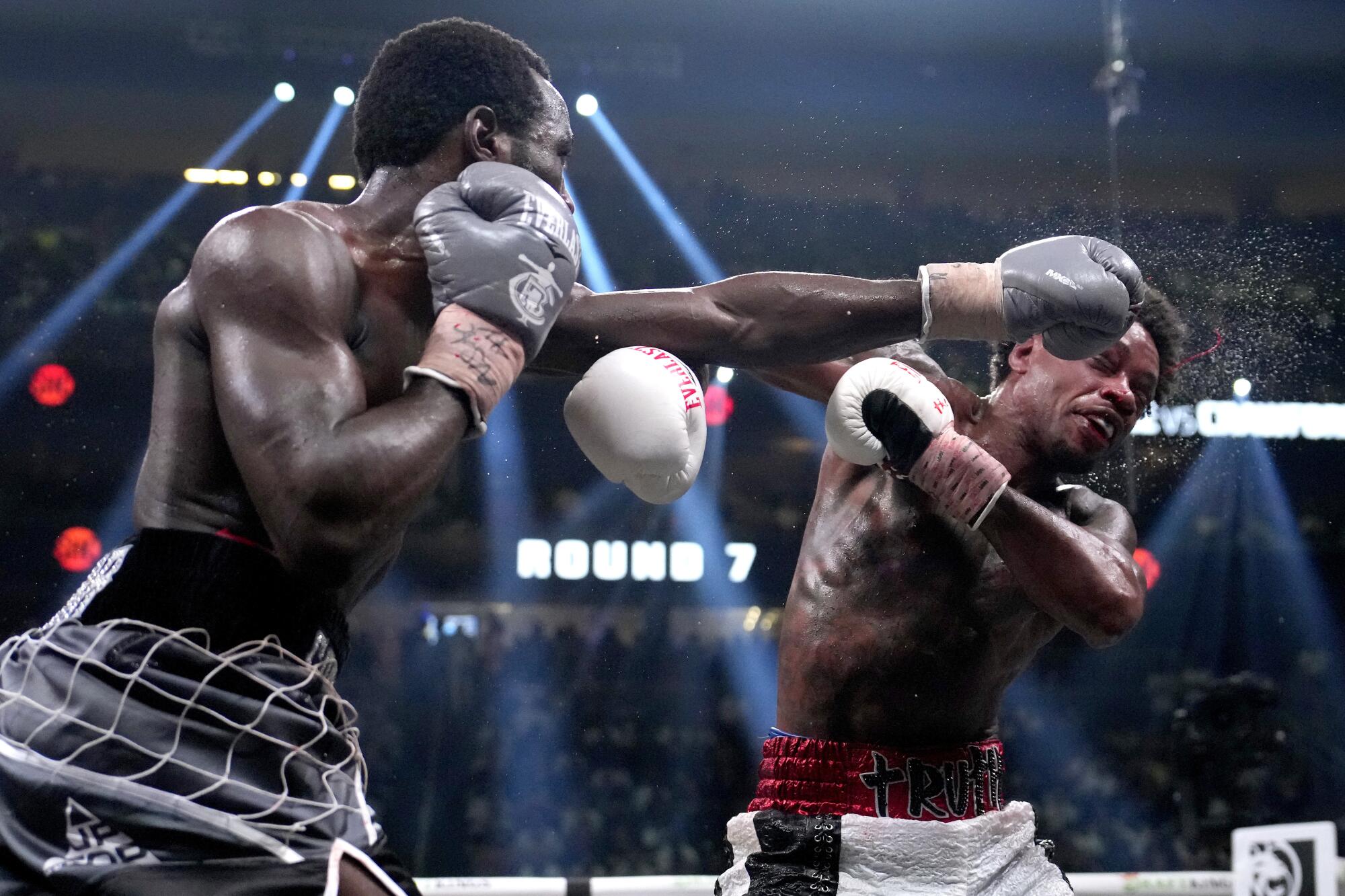 Terence Crawford, left, punches Errol Spence Jr.