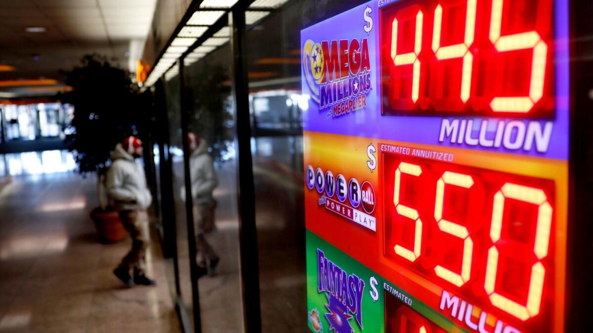 A sign at a store in Atlanta displays the Powerball and Mega Millions jackpots on Thursday,