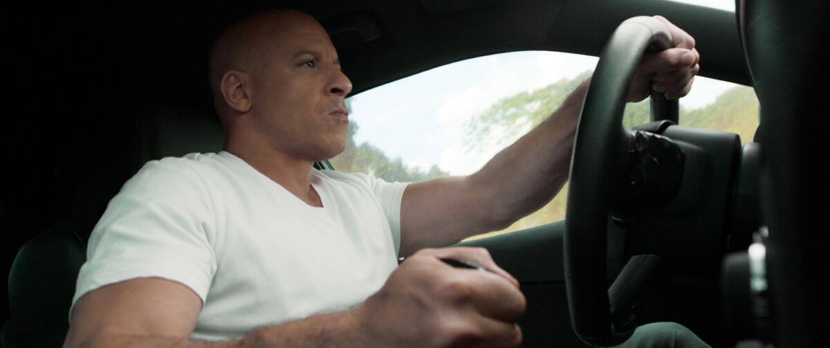 Vin Diesel drives a car window in a scene from “F9” a.k.a. “Fast & Furious Nine.”