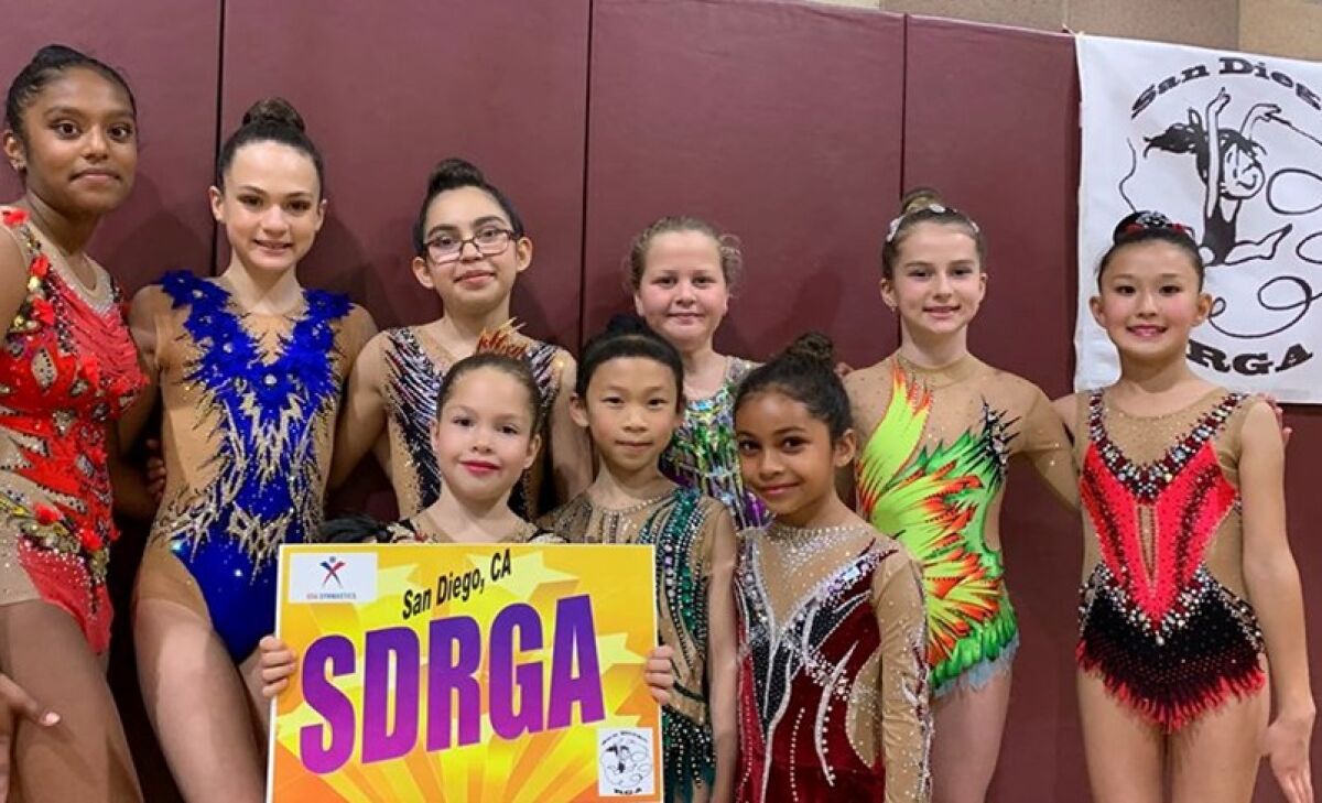 Level 9 and level 5 gymnasts of San Diego Rhythmic Gymnastics Academy: Back row: Siona Rahate, Ariana Kogan, Kayla Keller, Abigail Leychkis, Abigail Laur, Adiya Stamkulova; Front row: Alice Funtikov, Cyra Su, Tiana Ocasio