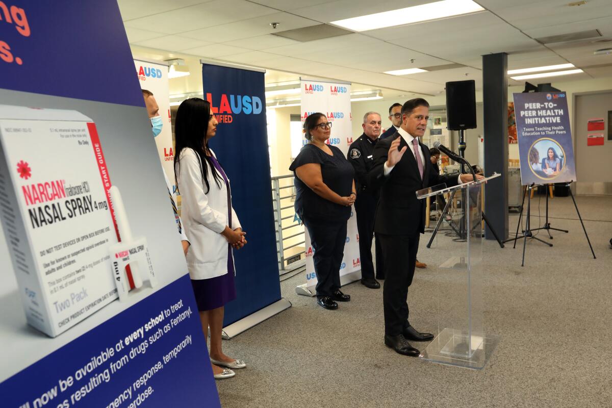 L.A. Unified Supt. Alberto M. Carvalho stands at a lectern with four other officials standing behind him.  