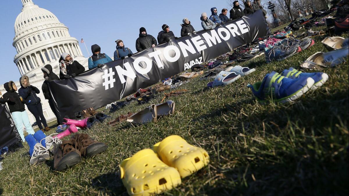 7,000 empty pairs of shoes for every child killed by guns in the U.S. since Sandy Hook cover the southeast lawn of U.S. Capitol Building on Tuesday, March 13.