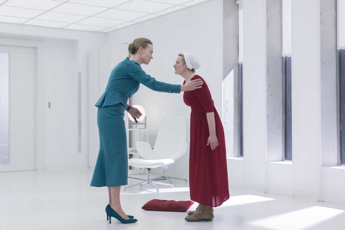 Yvonne Strahovski and Elisabeth Moss in a scene from Season 3 of "The Handmaid's Tale." 