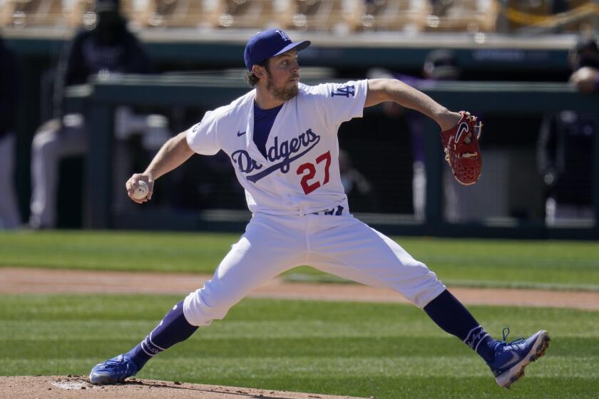 FILE - In this Monday, March 1, 2021, file photo, Los Angeles Dodgers starting pitcher Trevor Bauer throws.