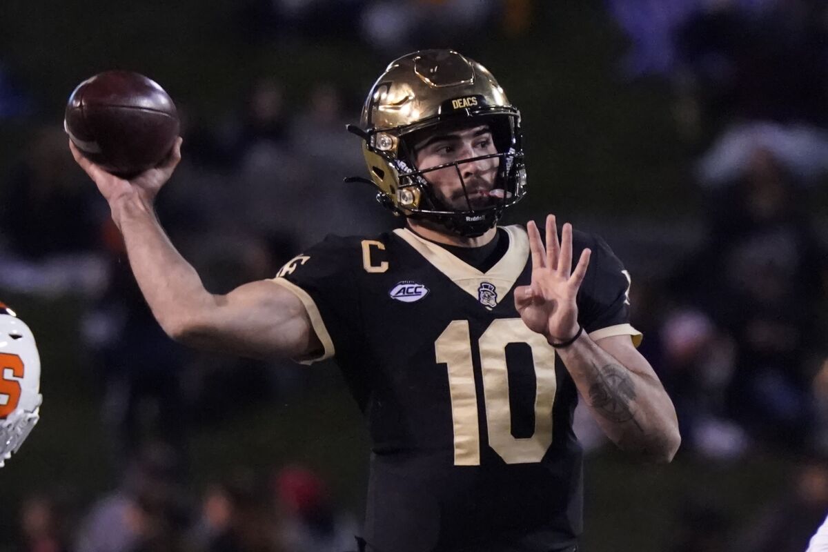Wake Forest quarterback Sam Hartman (10) looks to pass against Syracuse during the first half of an NCAA college football game in Winston-Salem, N.C., Saturday, Nov. 19, 2022. (AP Photo/Chuck Burton)