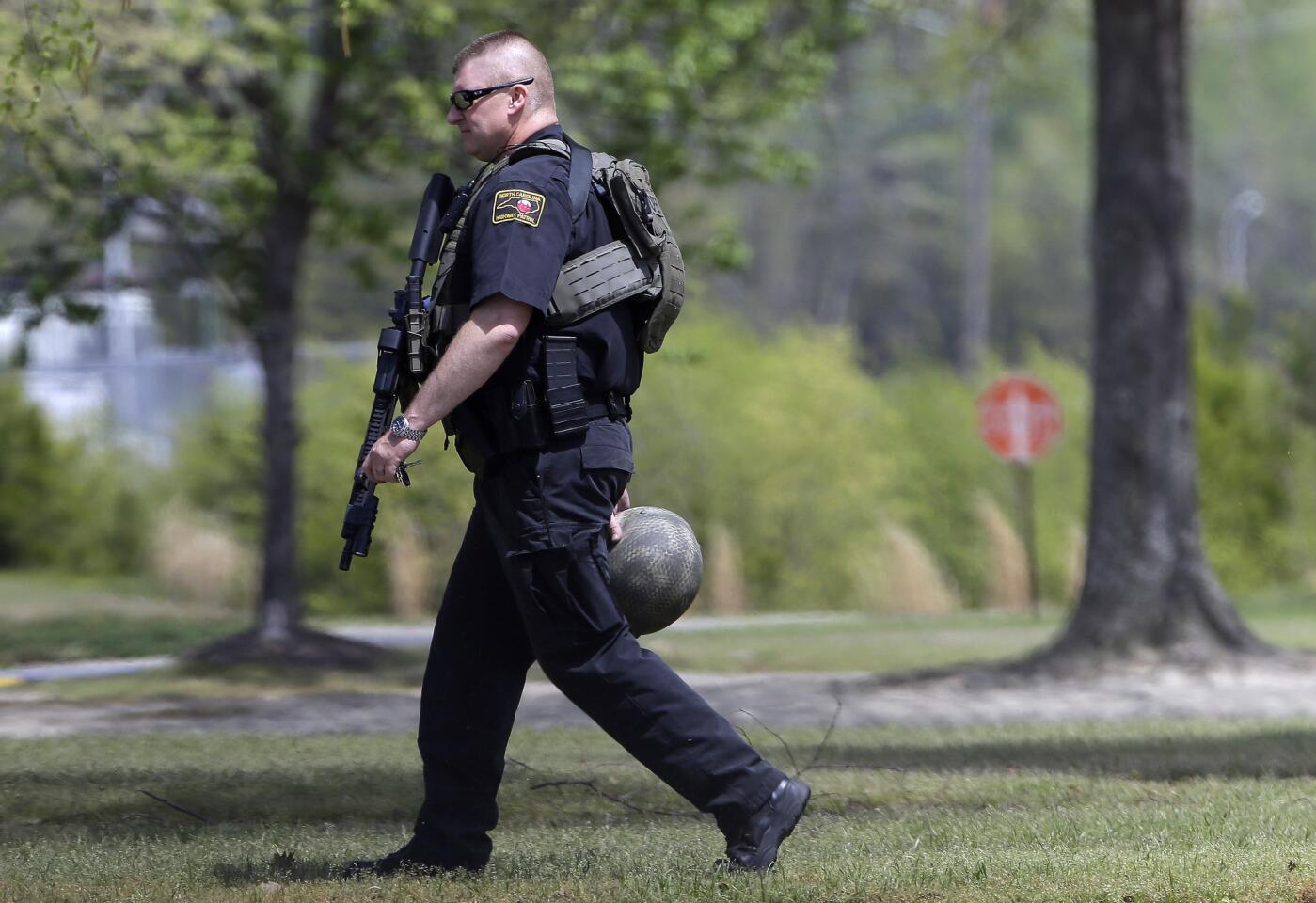 A North Carolina State Highway patrolman walks the grounds on campus following a shooting at Wayne Community College in Goldsboro, N.C.