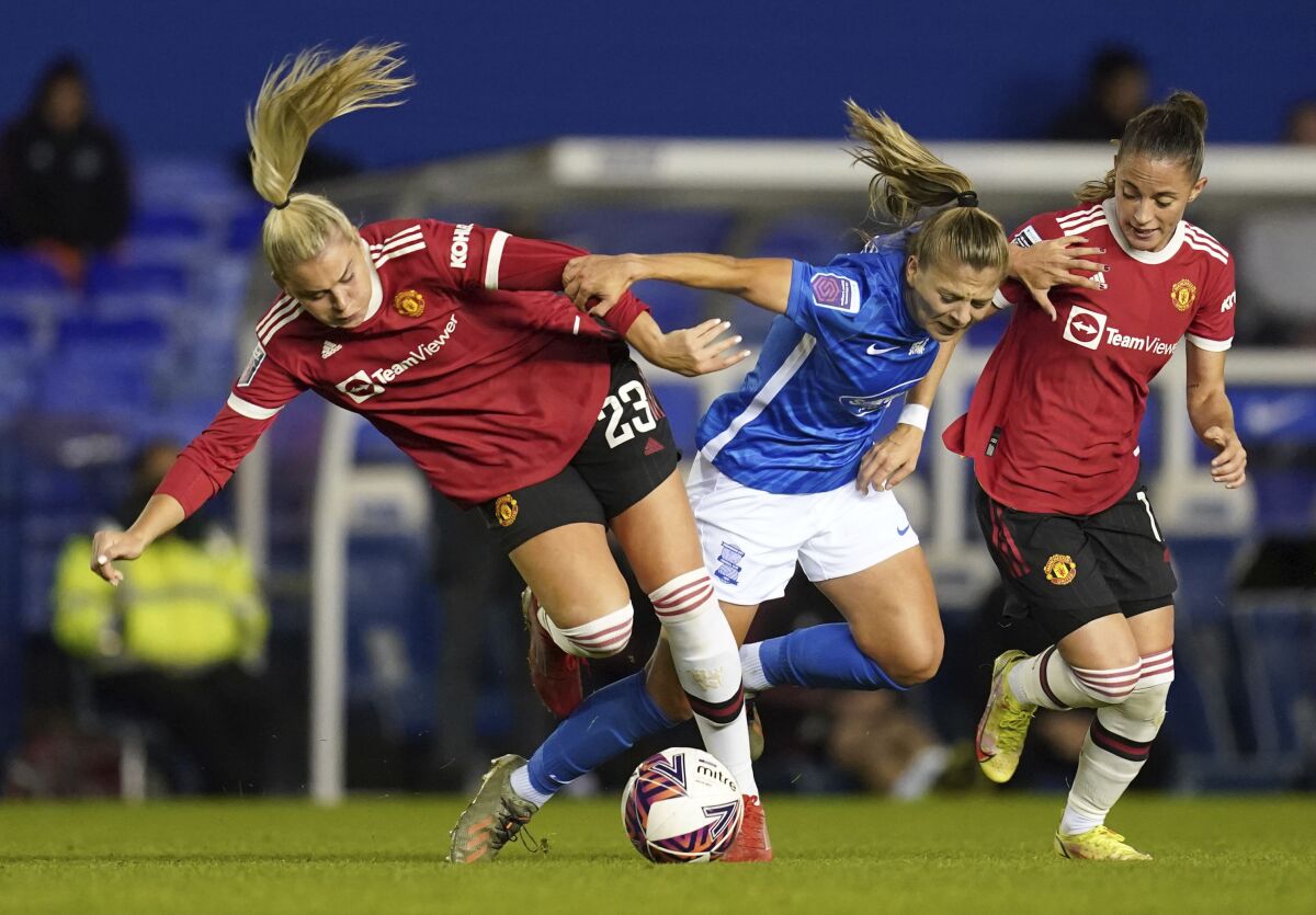 From left, Manchester United's Alessia Russo, Birmingham City's Veatriki Sarri, and Manchester United's Ona Batlle battle for the ball during the FA Women's Super League match at St. Andrew's, Birmingham, England, Sunday, Oct. 3, 2021. (David Davies/PA via AP)