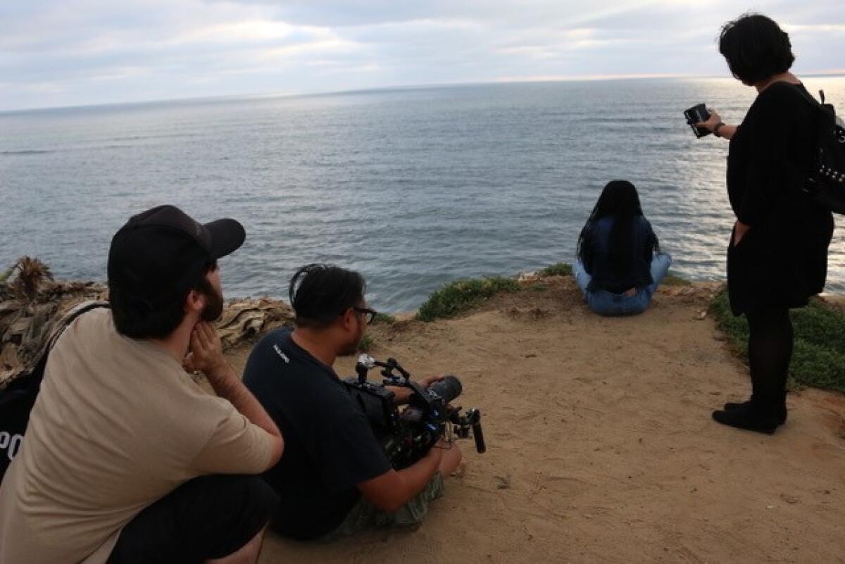 The "Friend of the World" crew films a scene at Sunset Cliffs.