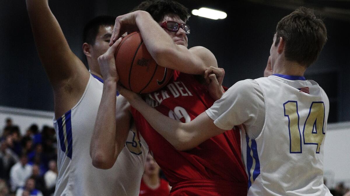 Mater Dei's Wilhelm Breidenbach is double teamed by Santa Margarita Shengzhe Li, left, and Jack McCloskey, right, during the first half at Santa Margarita High School on Wednesday.