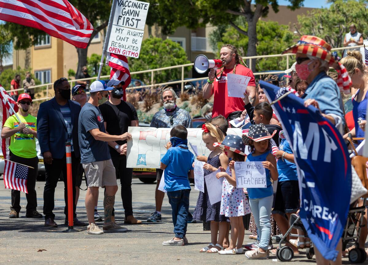 Lou Uridel, owner of the MetroFlex Gym in Oceanside, spoke on Wednesday at a protest in front of his business. Uridel was arrested and cited last week after refusing to close and has since been released.