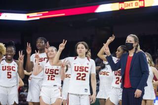 Southern California head coach Lindsay Gottlieb, right, and the players celebrate the team's win over Hawaii