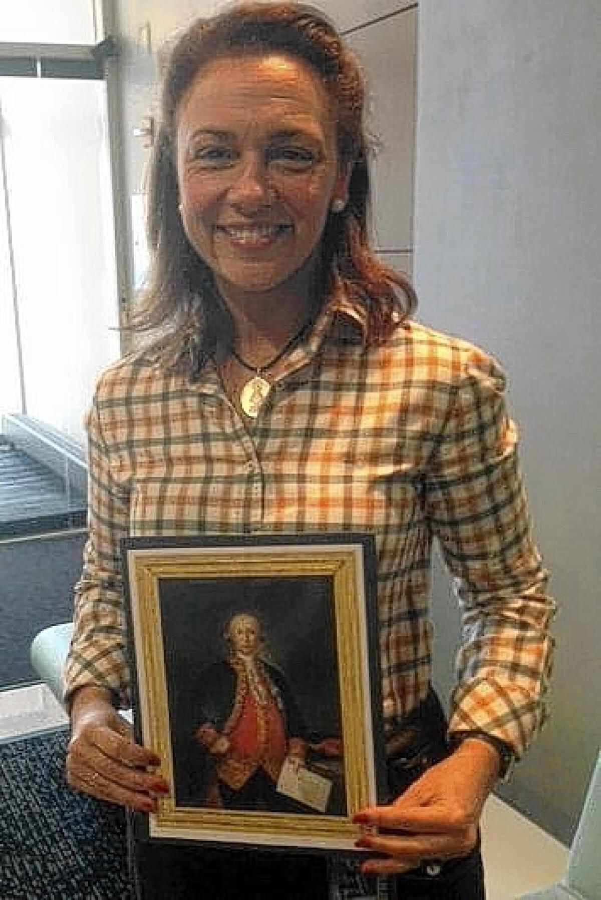 Teresa Valcarce with a portrait of Bernardo de Galvez.