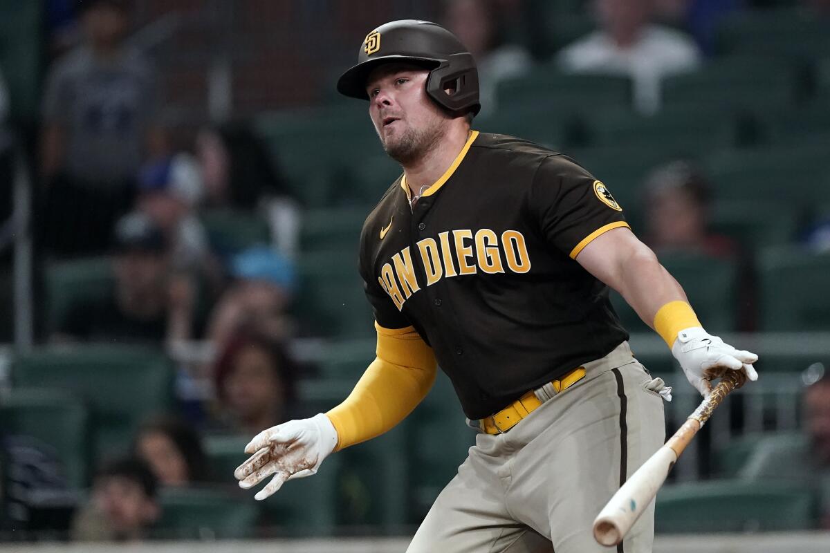 The Padres' Luke Voit watches his single in the ninth inning 