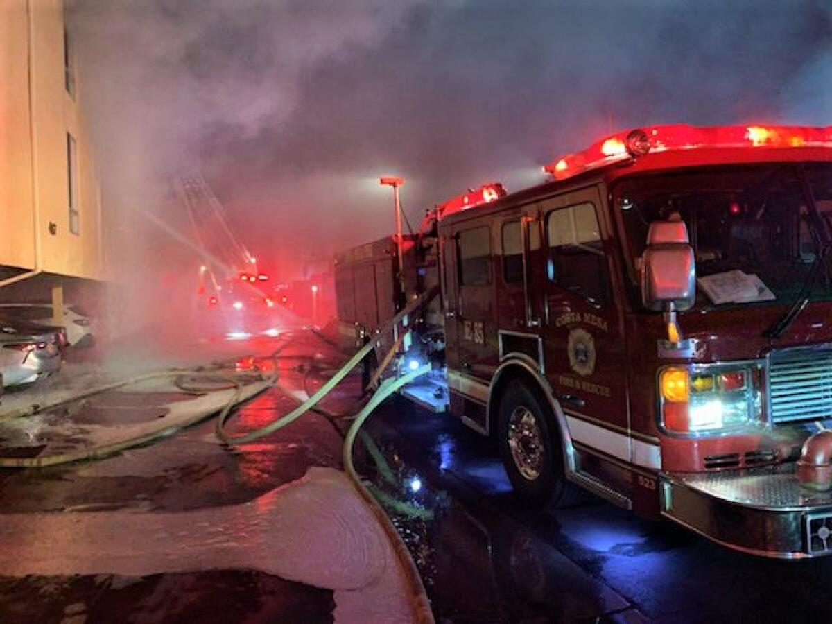 Firefighters from multiple agencies responded Tuesday to a three-alarm fire at a Costa Mesa apartment complex on Fair Drive.