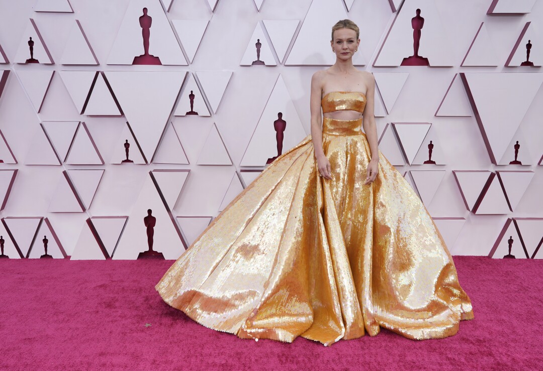 Carey Mulligan in a gold ballgown with a bandeau top.