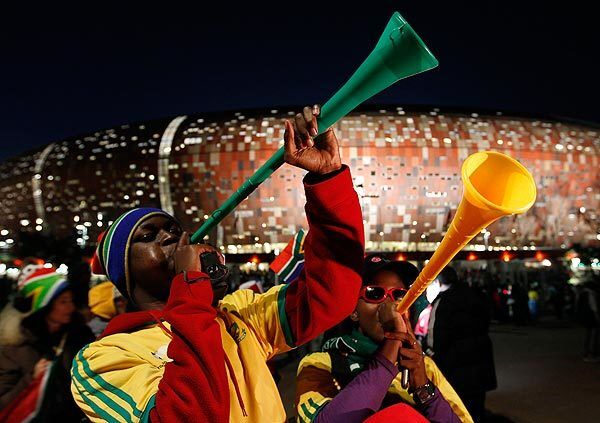 Fans blow vuvuzelas following the World Cup Group A match between South Africa and Mexico at Soccer City in Johannesburg, South Africa, on Friday. The game ended in a 1-1 tie.