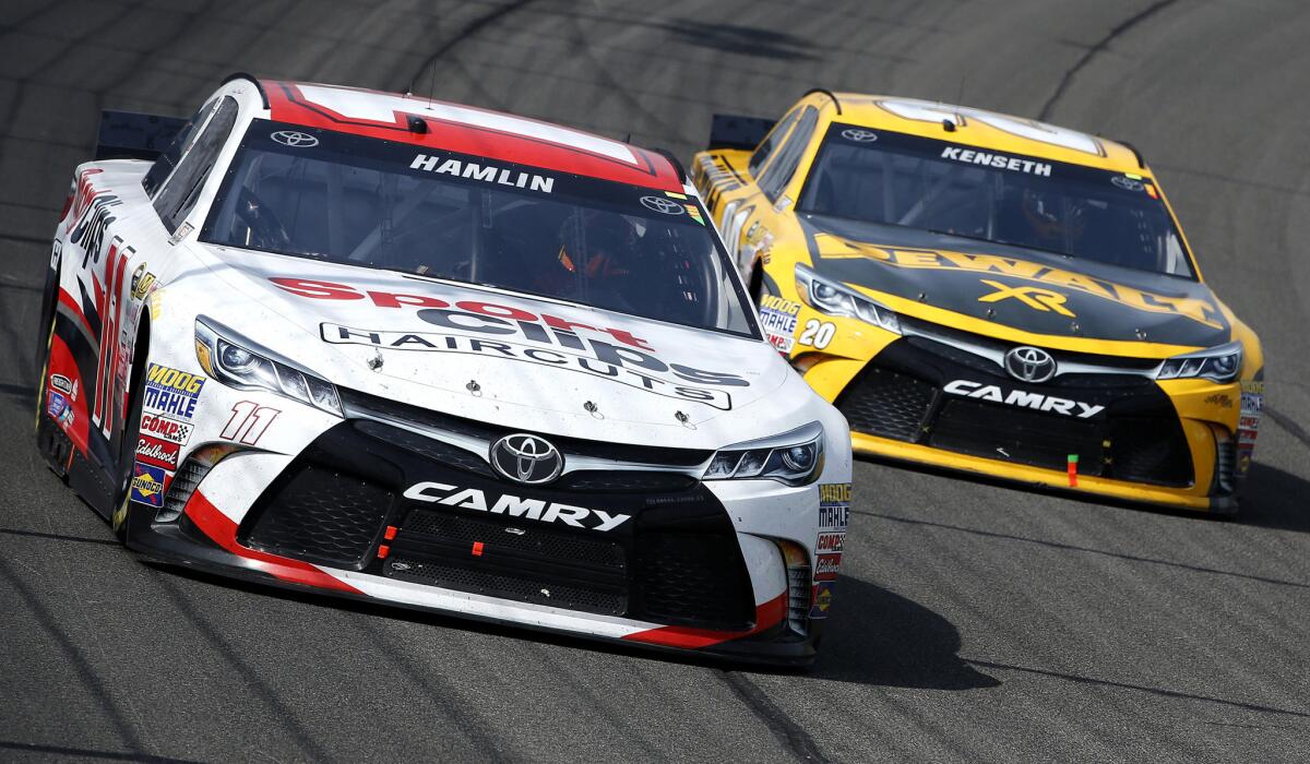 NASCAR drivers Denny Hamlin, in the No. 11 Sport Clips Toyota, and Matt Kenseth, in the No. 20 DeWalt Toyota, run side by side during the Sprint Cup Series Auto Club 400 in Fontana on Sunday.