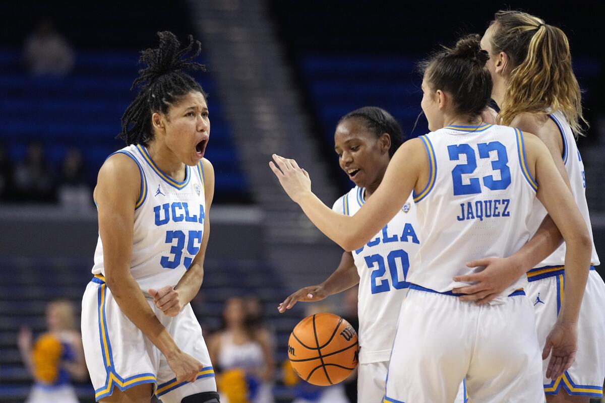 UCLA guard Camryn Brown, far left, celebrates with teammates (from left) Charisma Osborne, Gabriela Jaquez and Emily Bessoir.