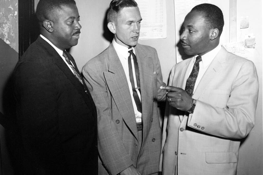 The Rev. Ralph D. Abernathy, left, Rev. Robert S. Graetz, center, and Rev. Dr. Martin Luther King Jr. talk during a bombing trial in Montgomery, Ala. in 1957.