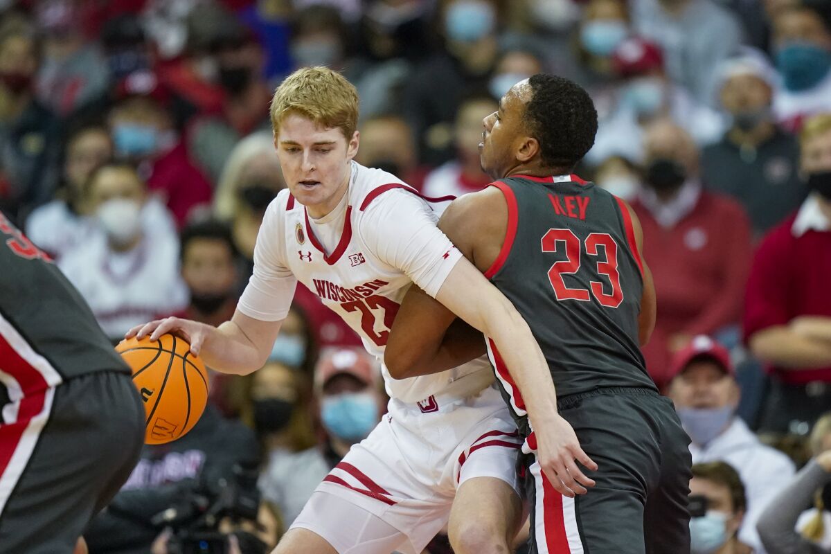 Wisconsin's Steven Crowl (22) drives on Ohio State's Zed Key (23) during the first half of an NCAA college basketball game Thursday, Jan. 13, 2022, in Madison, Wis. (AP Photo/Andy Manis)