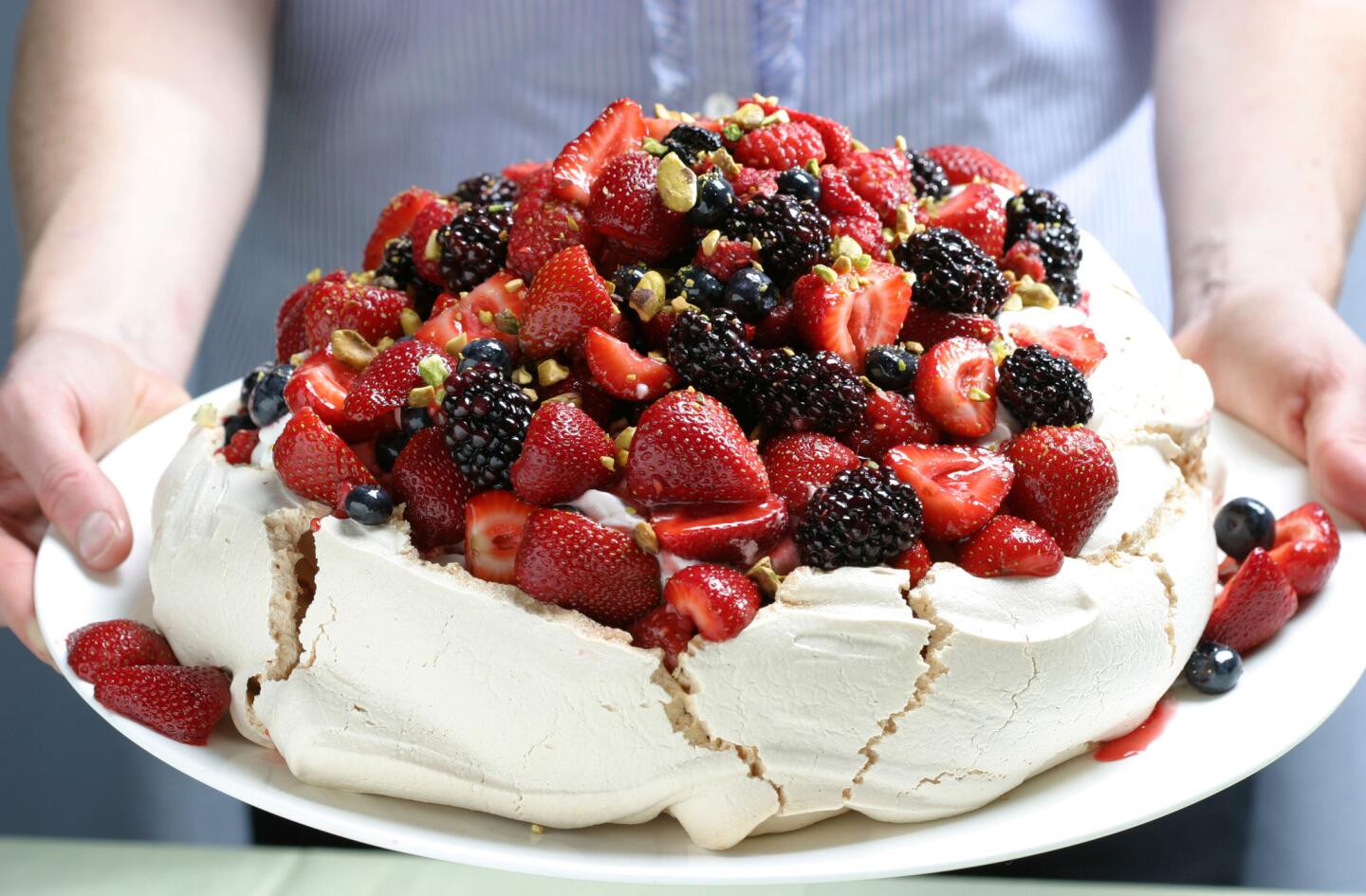Sure to impress your guests. Recipe: Berry Pavlova with vanilla whipped cream and pistachios