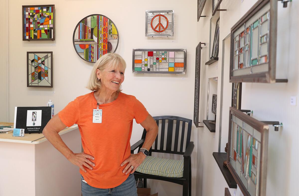 Stained-glass artist Barbara Bond displays her work at the Sawdust Art Festival.
