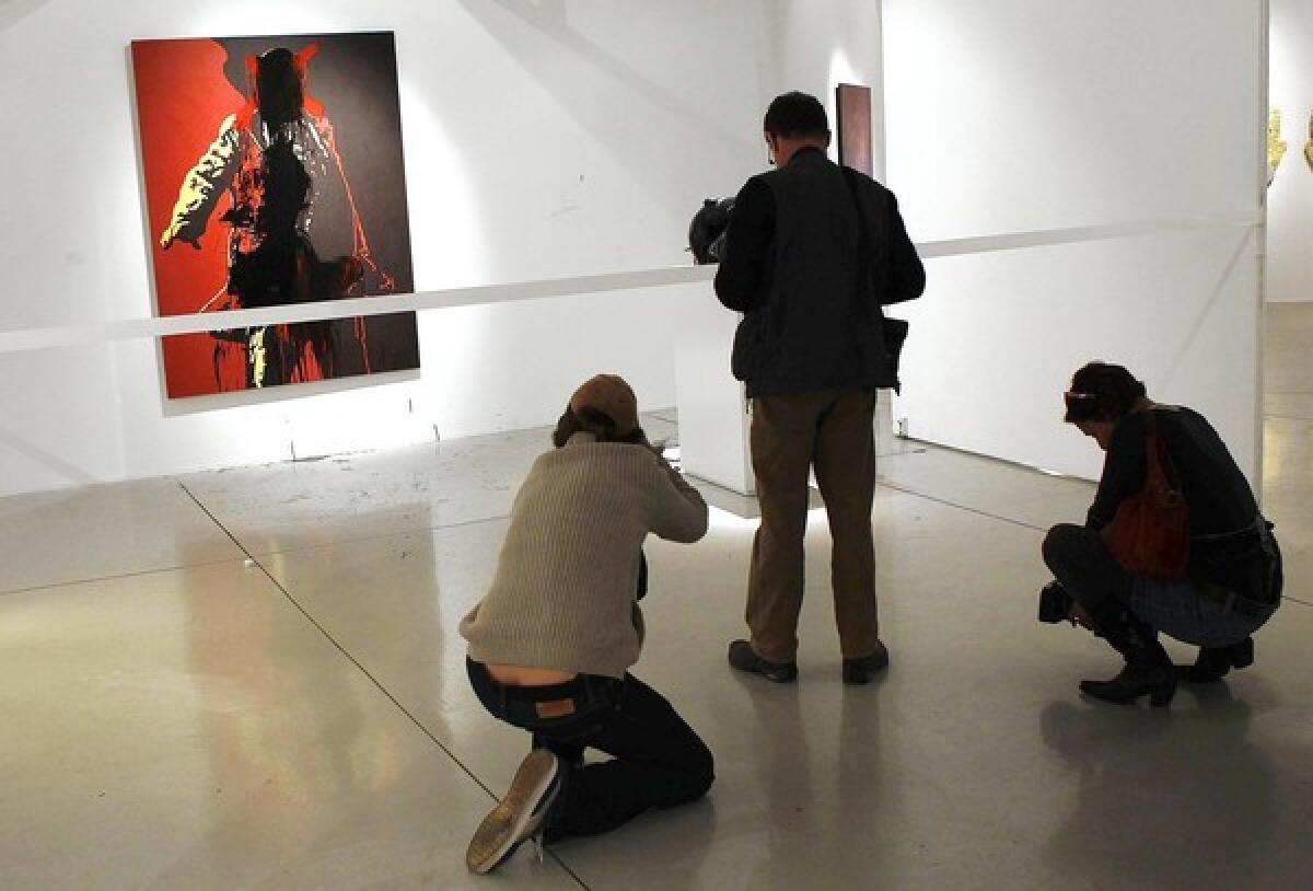 A controversial portrait of South African President Jacob Zuma, photographed by journalists last week, above, after it was defaced by vandals, has been removed from the Goodman Gallery in Johannesburg.