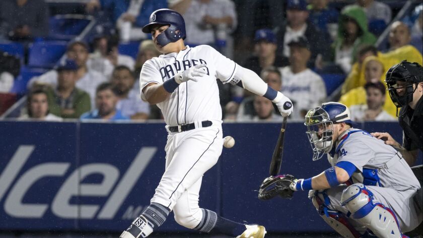 Christian Villanueva fouls off a pitch during the Padres game gainst the Dodgers Friday in Monterrey, Mexico.