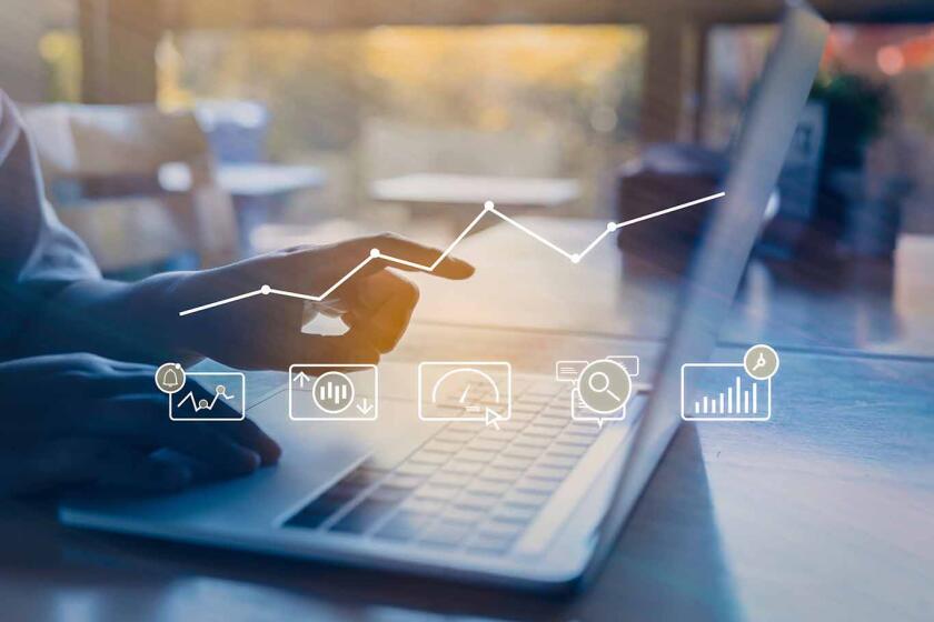 Person using a laptop computer with digital marketing technology concept