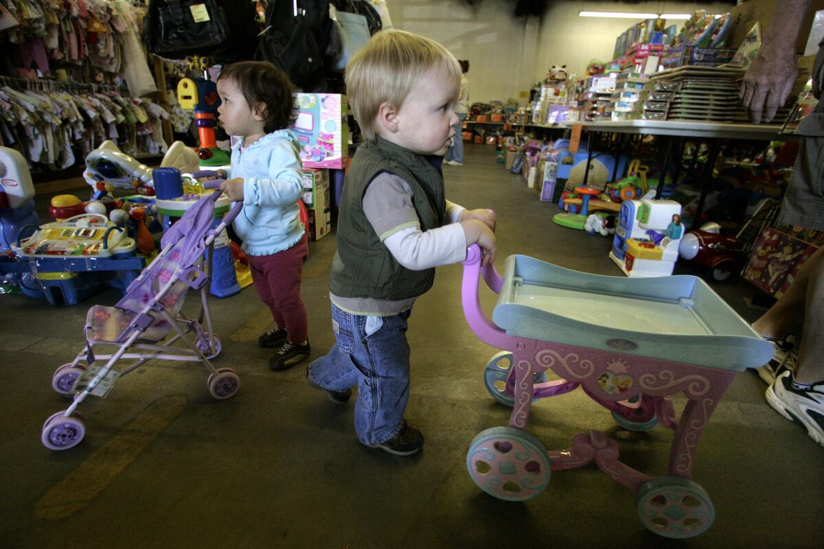Gillian Nail, 17 months, and Cooper Nelson, 20 months, play with strollers at an L.A. Kids Consignment Sale in 2008.