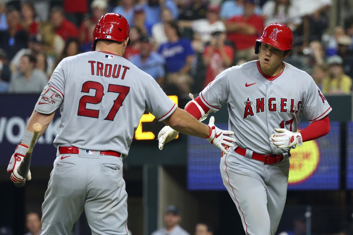 Angels' Shohei Ohtani celebrates with Mike Trout.