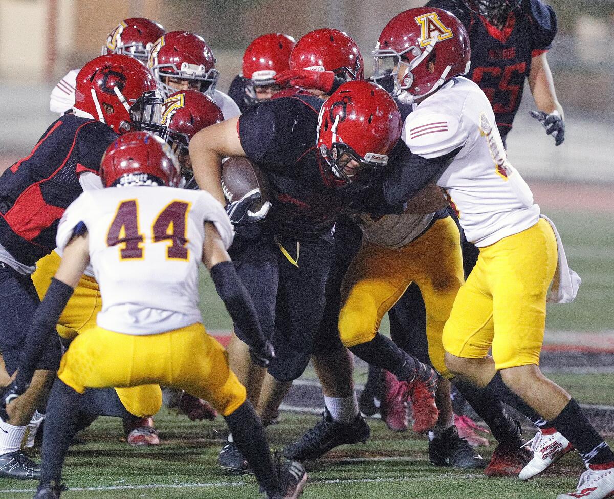 On a fourth down play, Glendale's Dennis Perez pounds through the Arcadia defense for a first down in a Pacific League football game at Glendale High School on Thursday, October 3, 2019.
