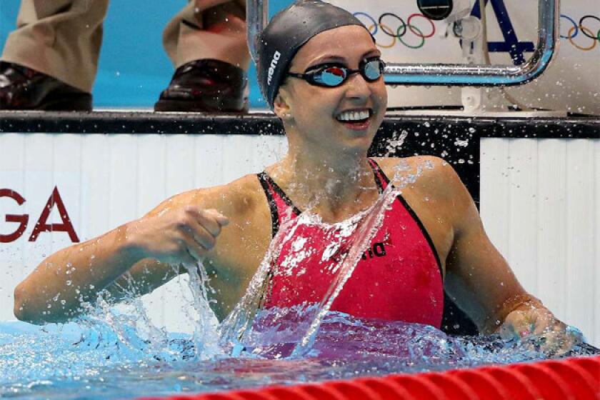 U.S. swimmer Rebecca Soni celebrates with a splash after winning the women's 200-meter breaststroke, setting a world record at 2:19:59 at the 2012 London Olympics.