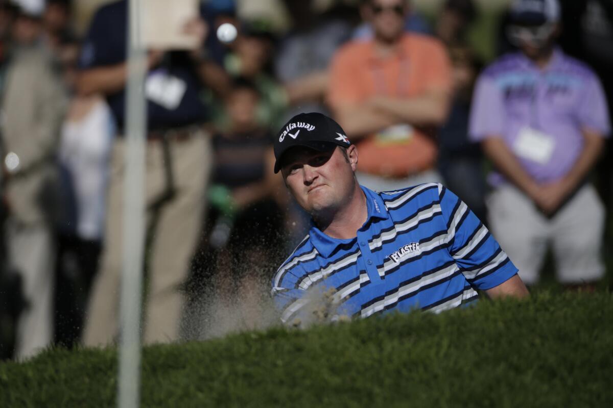 Jason Kokrak blasts out of a greenside bunker at No. 16, helping him save par during the final round of the Northern Trust Open at Riviera Country Club.