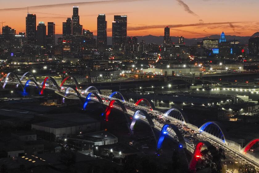 Los Angeles, CA - July 08: After more than six years of construction, Los Angeles officials light the 20 arches dubbed the "Ribbon of Light" on the new 6th Street Viaduct during a ceremony at dusk that begins a three-day community celebration to mark its completion, connecting Boyle Heights and the downtown Arts District and replaces one of the city's structural landmarks. Photo taken 6th Street Viaduct, Los Angeles, CA on Friday, July 8, 2022. The four-lane bridge will connect Boyle Heights and the Arts District across a 3,060 foot-breadth that spans the Los Angeles River, 101 Freeway, railroad tracks and Metrolink tracks. Dubbed the "Ribbon of Light," the $588-million project is considered the most extensive bridge project in the city's history and took six years to complete, with delays due to COVID-19. The event featured a formal ribbon-cutting ceremony at which city officials held a news briefing from L.A. Mayor Eric Garcetti, Councilman De Leon and city engineer Gary Lee Moore. The new viaduct's "Ribbon of Light" design, with its 20 arches, was created by the architectural firm HNTB Corp. and Los Angeles-based architect Michael Maltzan. (Allen J. Schaben / Los Angeles Times)