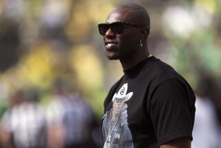 Former NFL football player Terrell Owens looks on during warm ups before an NCAA football game between Colorado and Oregon
